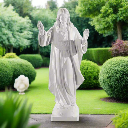32-inch Sacred Heart of Jesus statue in Italian marble, displayed in a peaceful outdoor setting with manicured greenery and soft lighting