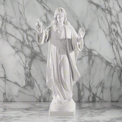 32-inch Sacred Heart of Jesus statue in Italian marble, displayed in a peaceful outdoor setting with manicured greenery and soft lighting
