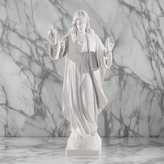 32-inch Sacred Heart of Jesus statue in Italian marble, displayed in a peaceful outdoor setting with manicured greenery and soft lighting
