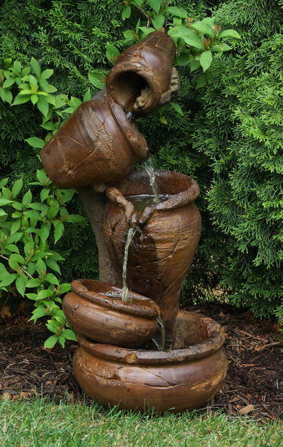 Juggling Act Four Urns Fountain four different vessels flowing water one to the other.