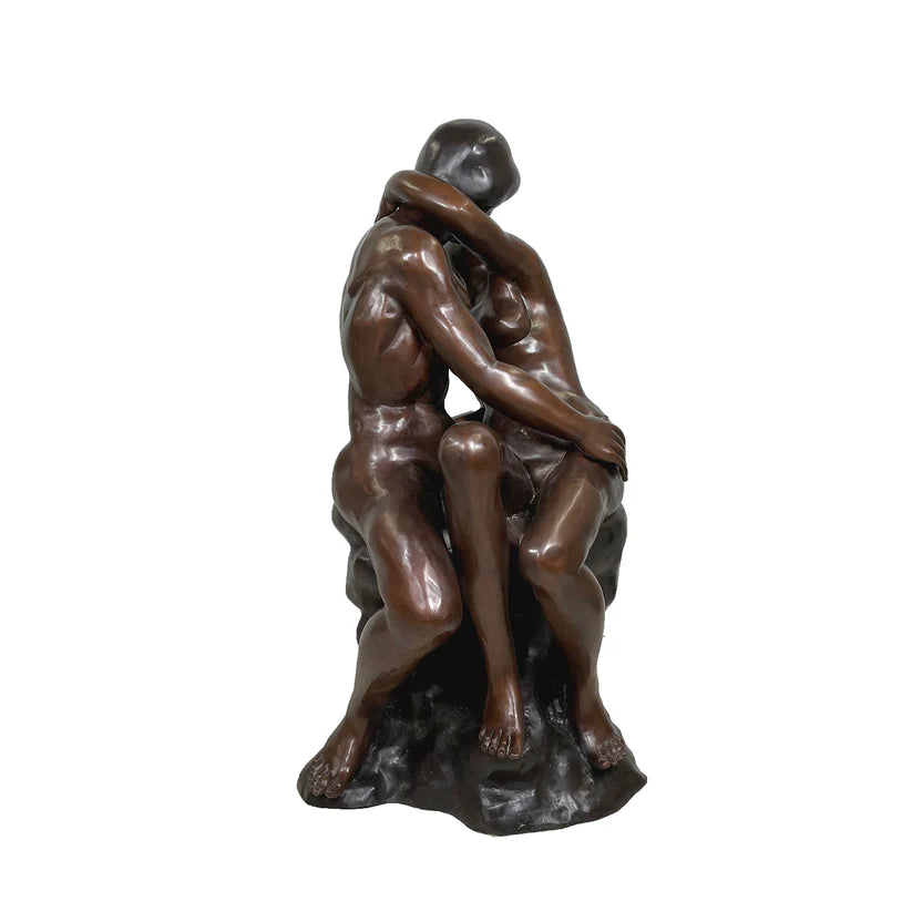 Bronze statue of two figures embracing on a white background Kissing by artist Rodin
