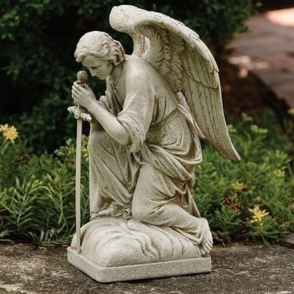 Kneeling Male with Sword Statue of an angel in a garden setting