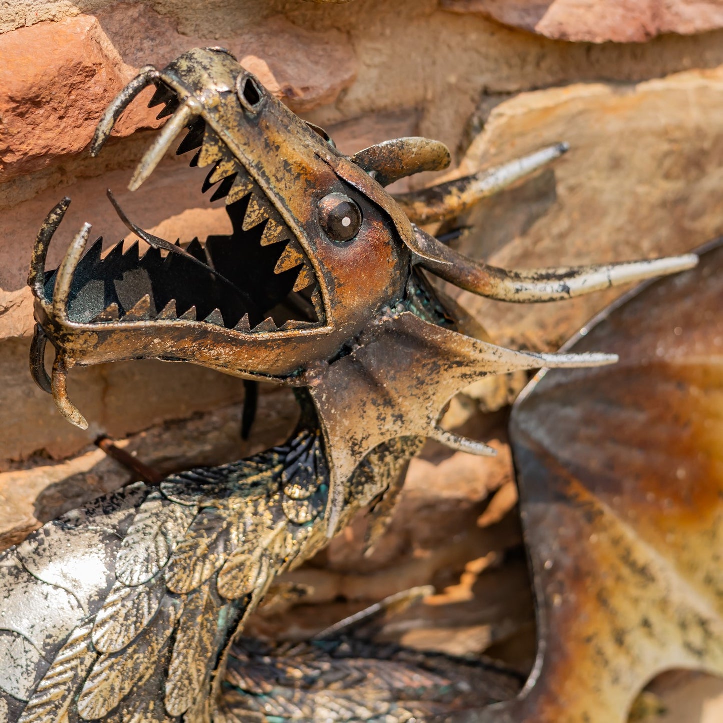 Close up of head Metal serpent dragon wall hanging sculpture with coiled body and wide wings