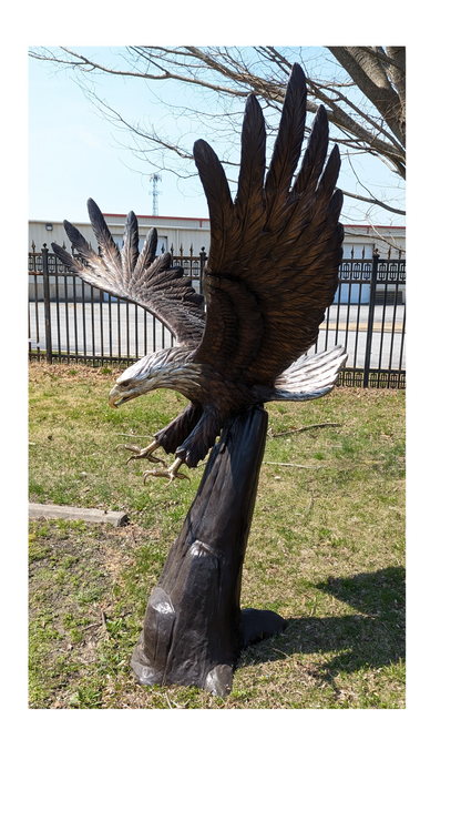 Large solid bronze eagle sculpture in dramatic flight pose