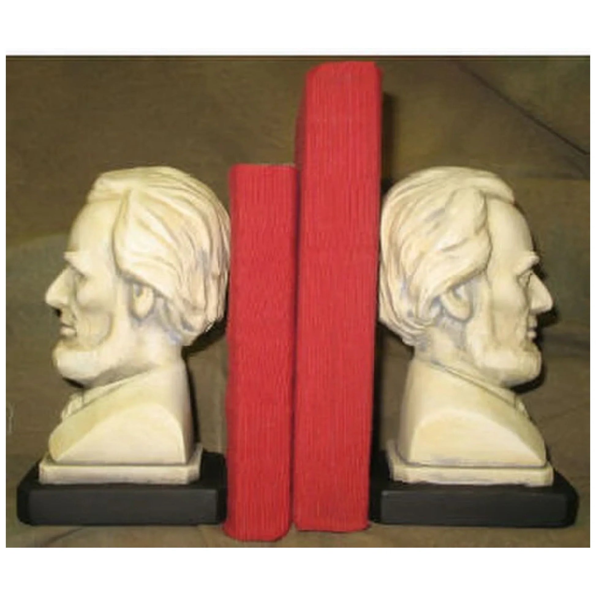 Busts of Lincoln Bookend set, white plaster, holding two red books up.