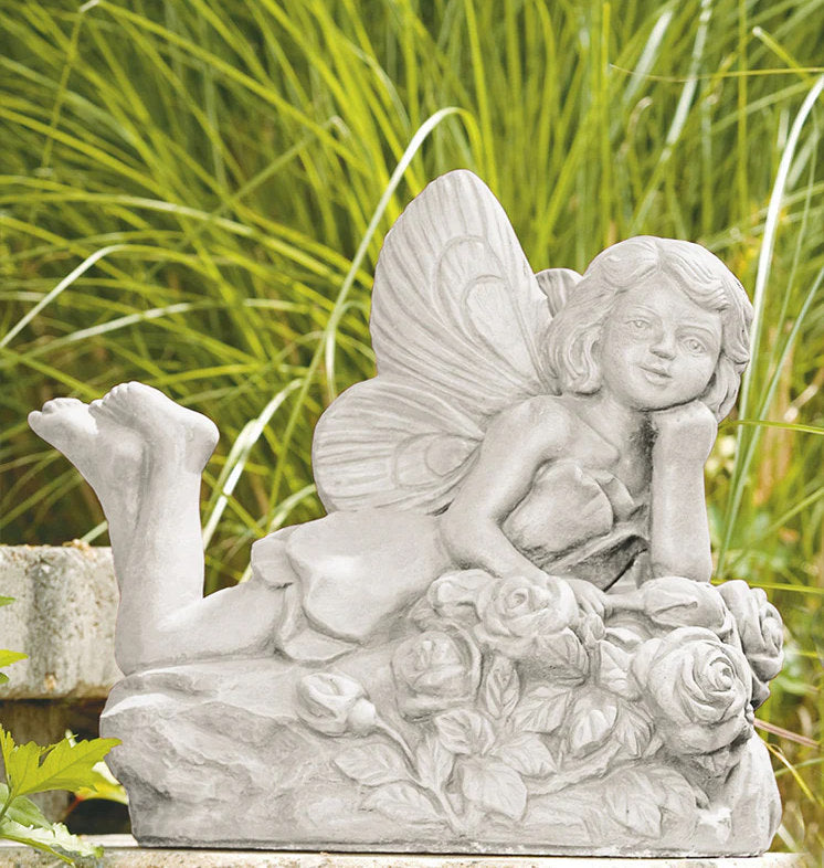 Laying rose fairy cast stone garden statue resting on sculpted roses made in USA