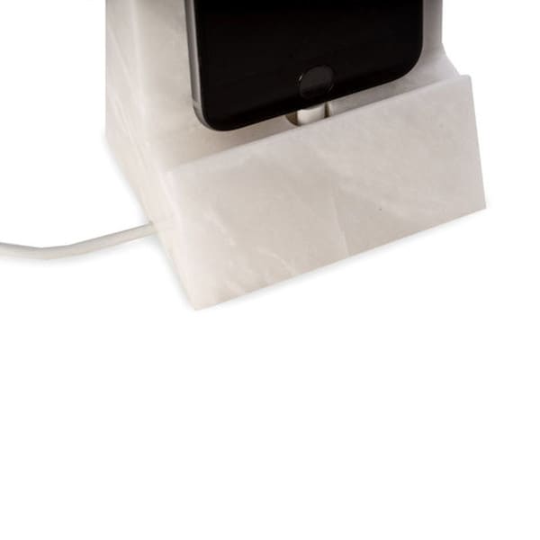 Solid white marble phone holder has a hole for charging cords pure