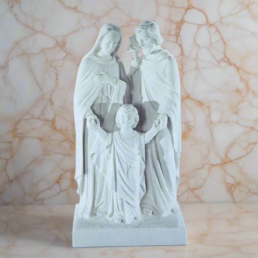 20-inch Sacred Family statue in white Italian marble, displayed outdoors in a garden setting with soft natural lighting