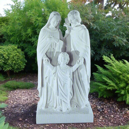 20-inch Sacred Family statue in white Italian marble, displayed outdoors in a garden setting with soft natural lighting