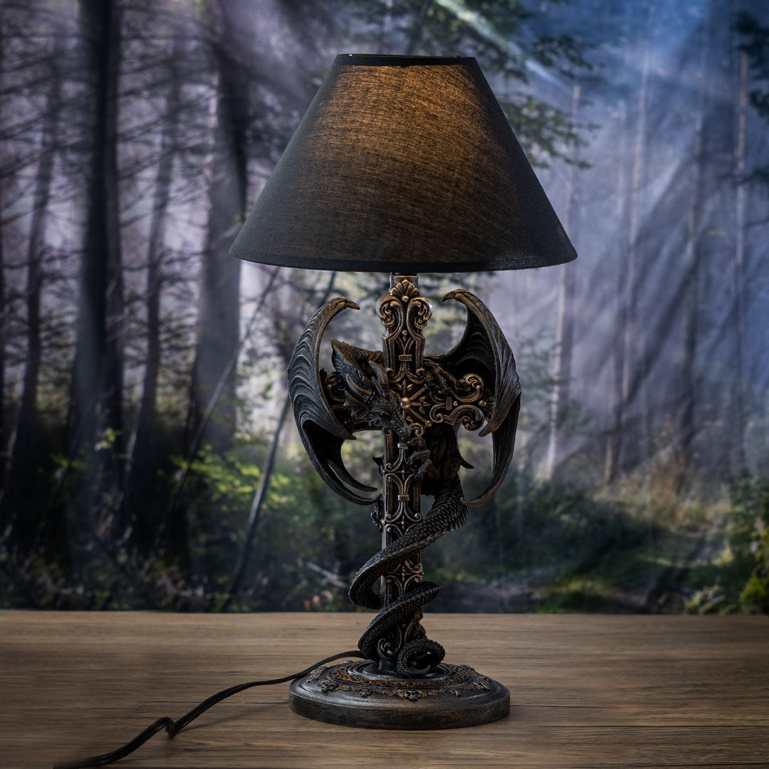 Dragon sculptural table lamp featuring a winged dragon wrapped around a gothic cross column