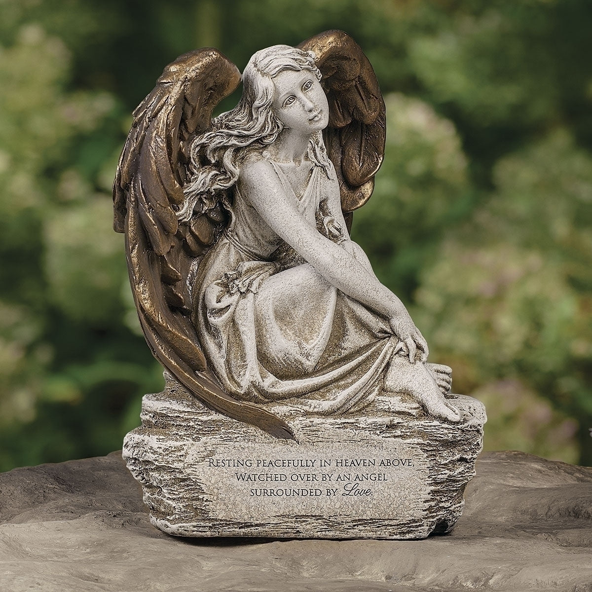 Memorial angel statue with wings and inscribed verse surrounded by love