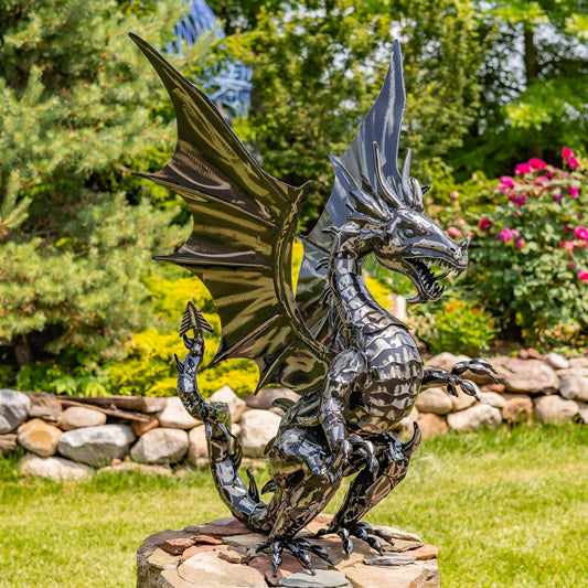 Metallic dragon sculpture in a garden setting with greenery and flowers.