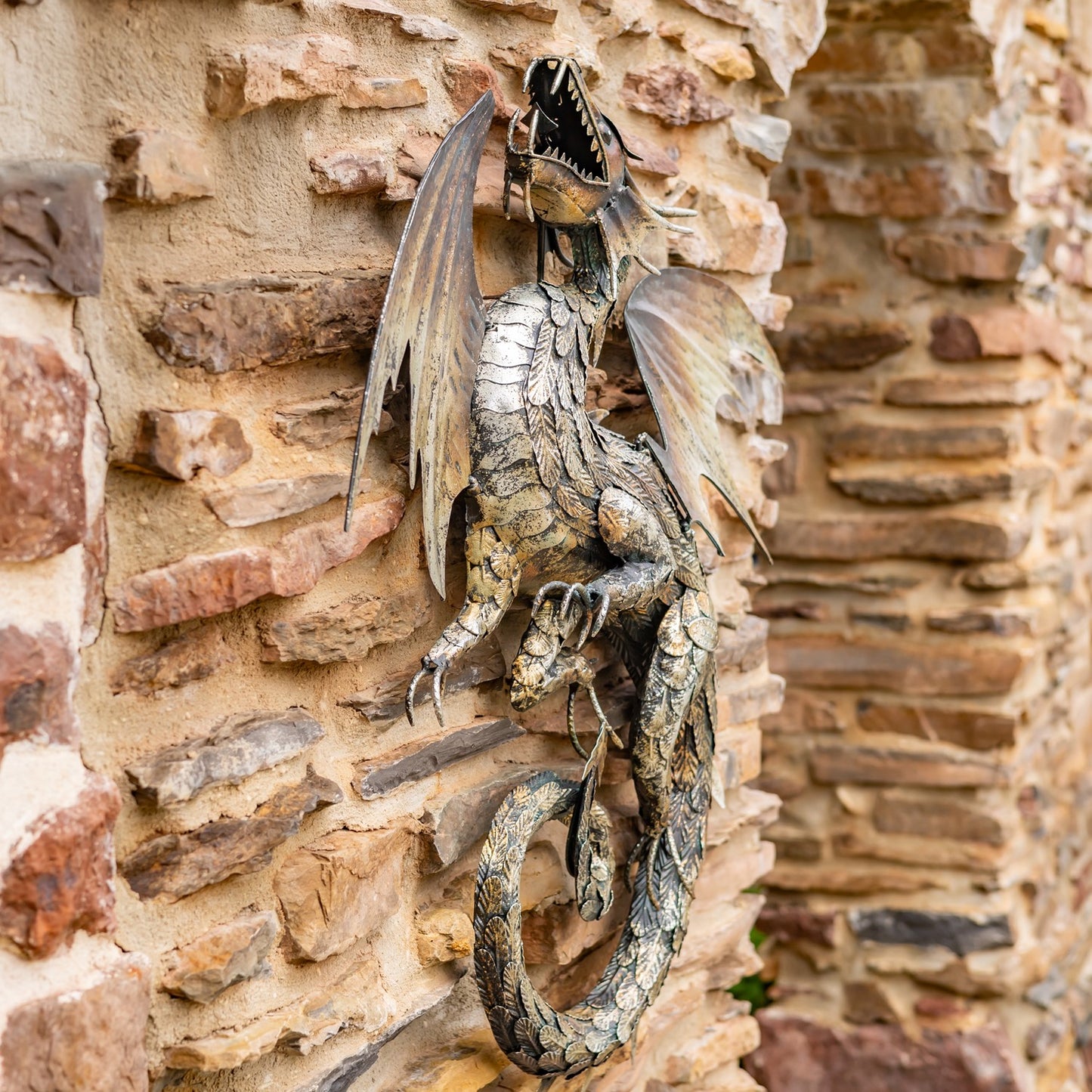 Decorative dragon sculpture on a stone wall side view large scale statue