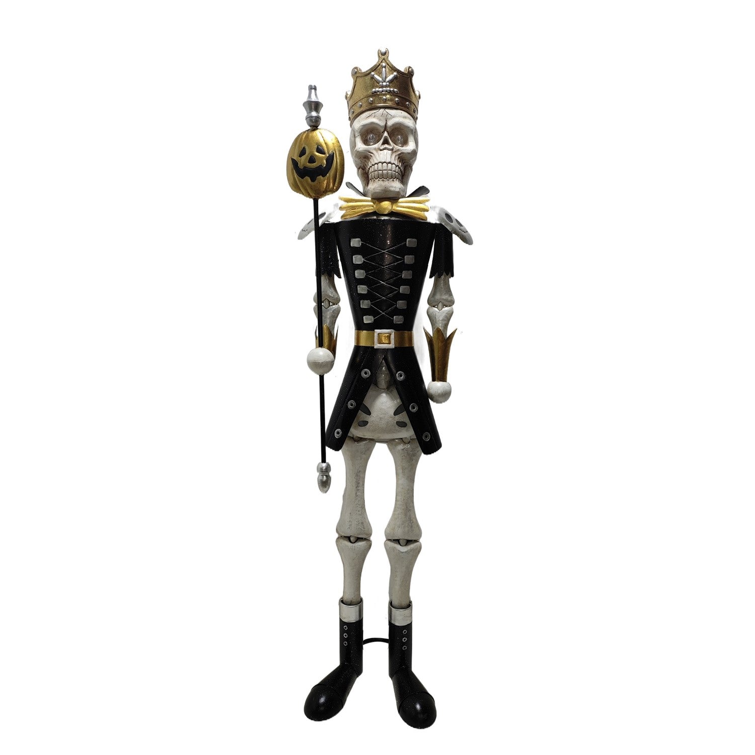 A skeleton king nutcracker figurine wearing a black and gold military-style uniform, gold crown, and holding a jack-o'-lantern staff, isolated on a white background.