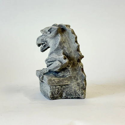 Stone gargoyle sculpture on a white background cornerstone statue