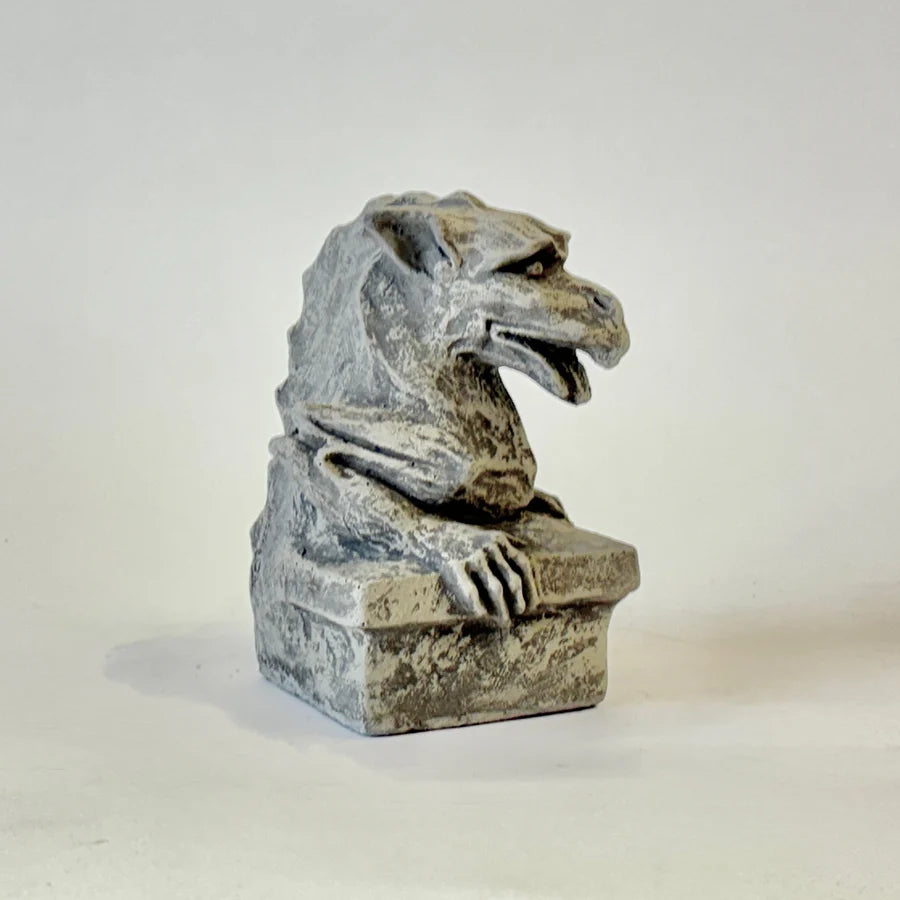 Stone gargoyle sculpture on a white background