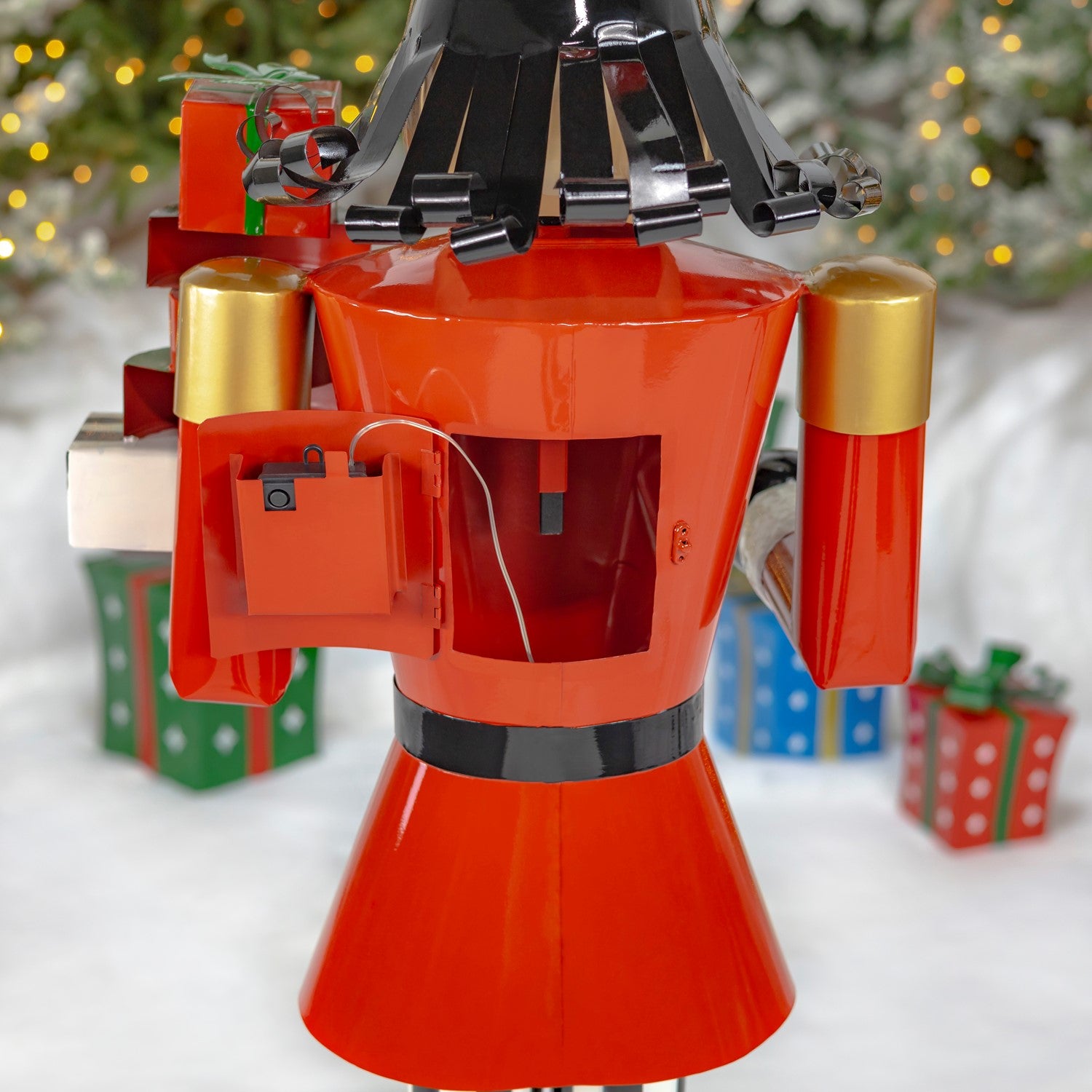 Nutcracker with Christmas Gifts Statue  shows how to install batteries