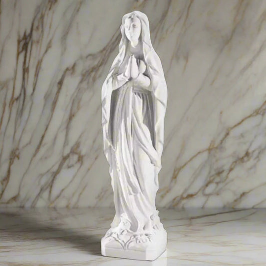 43.5-inch Our Lady of Lourdes statue in white Italian marble, displayed in a tranquil garden shrine with floral arrangements and greenery