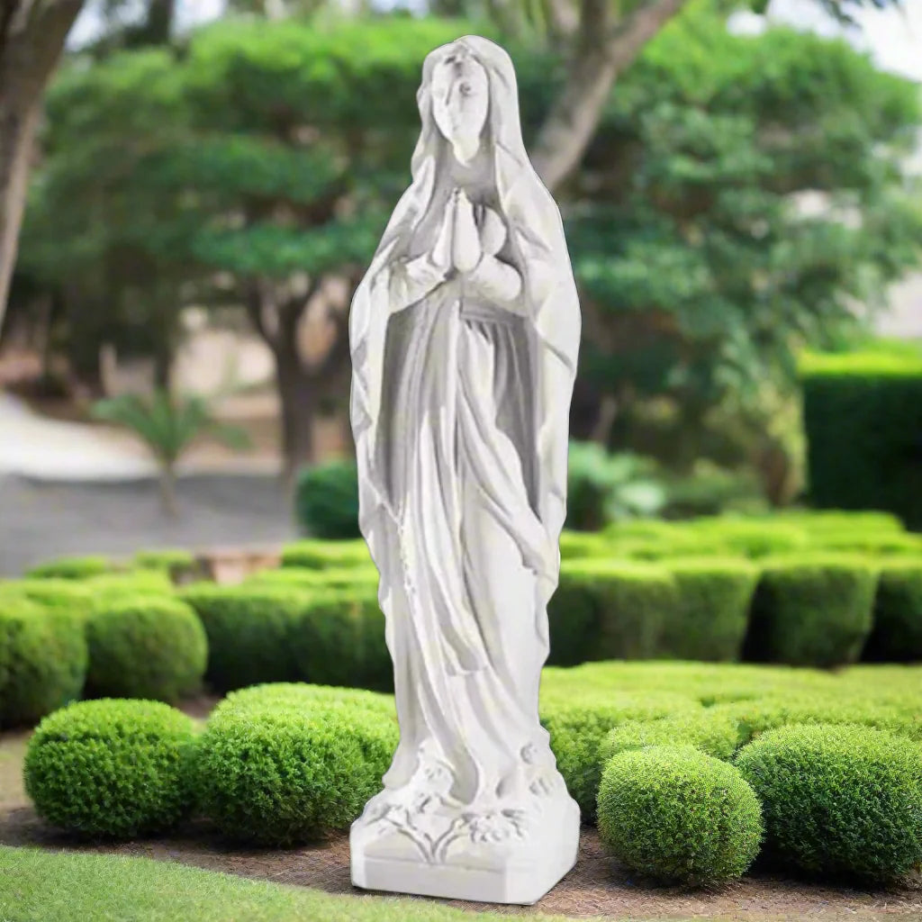 60.25-inch Italian marble Our Lady of Lourdes statue, placed in a beautifully landscaped garden shrine with surrounding flowers and stones