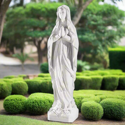 60.25-inch Italian marble Our Lady of Lourdes statue, placed in a beautifully landscaped garden shrine with surrounding flowers and stones