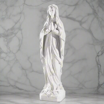 60.25-inch Italian marble Our Lady of Lourdes statue, placed in a beautifully landscaped garden shrine with surrounding flowers and stones