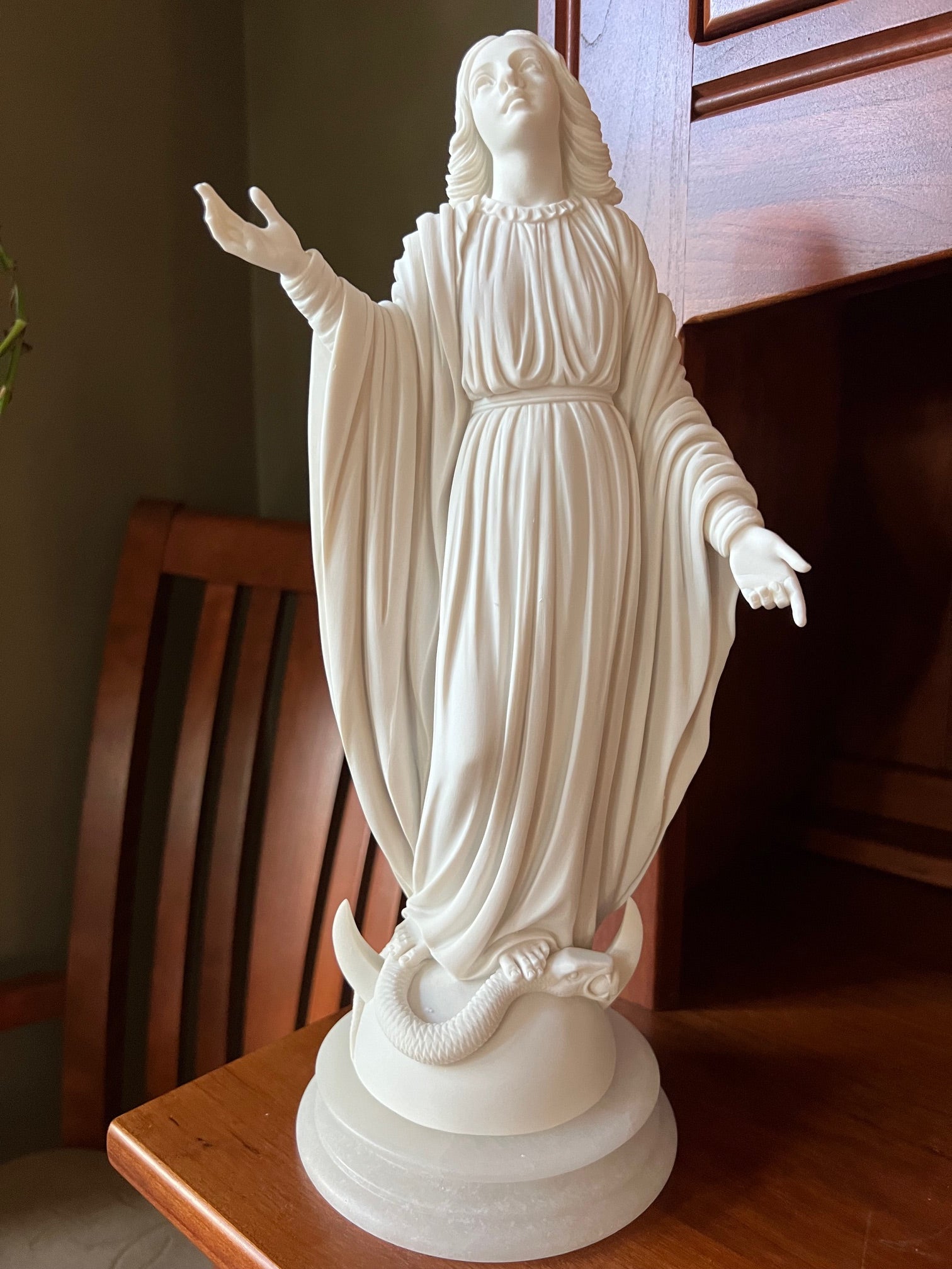 Our Lady of the Miraculous Medal statue with serpent underfoot on marble base