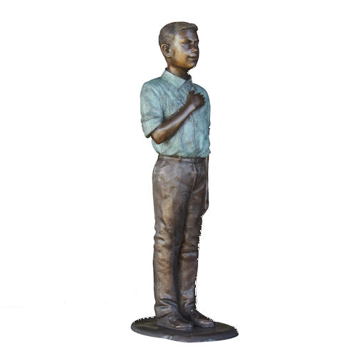 Bronze statue of a young boy in a shirt and pants on a white background Life-Size Bronze Pledge of Allegiance Sculpture 