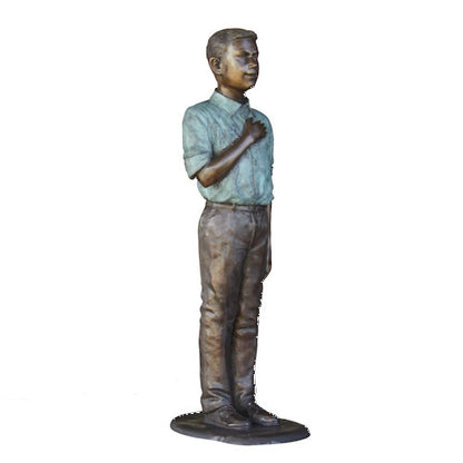 Bronze statue of a young boy in a shirt and pants on a white background Life-Size Bronze Pledge of Allegiance Sculpture 