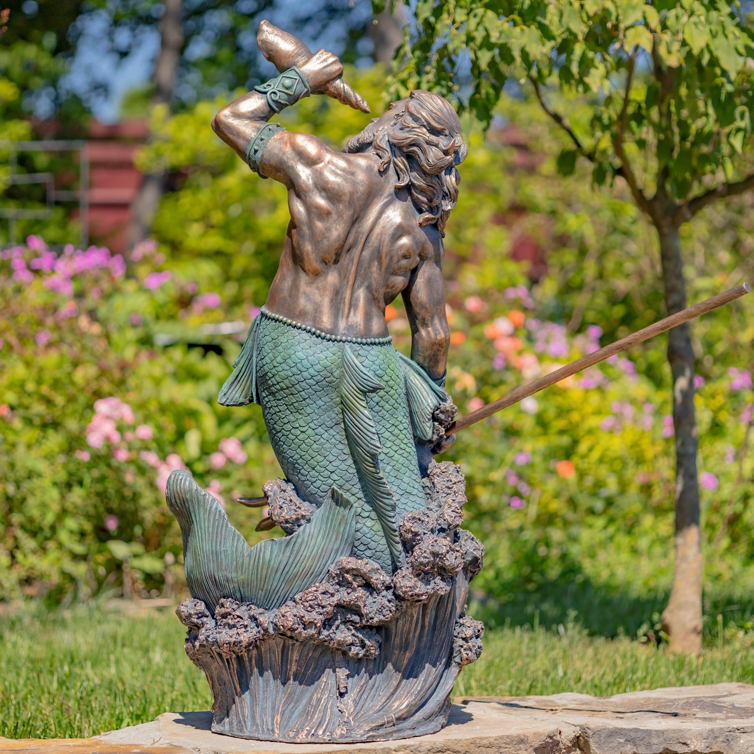 Back view Nautical merman statue blowing shell with bronze body and green patina tail