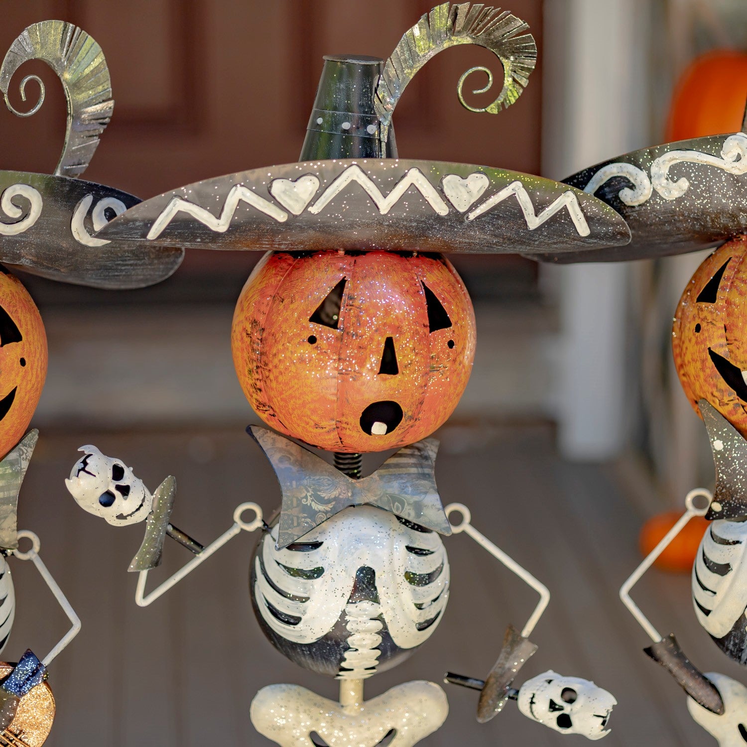 Pumpkin-headed skeleton shaking maracas in mariachi costume