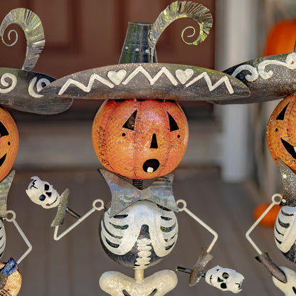 Pumpkin-headed skeleton shaking maracas in mariachi costume