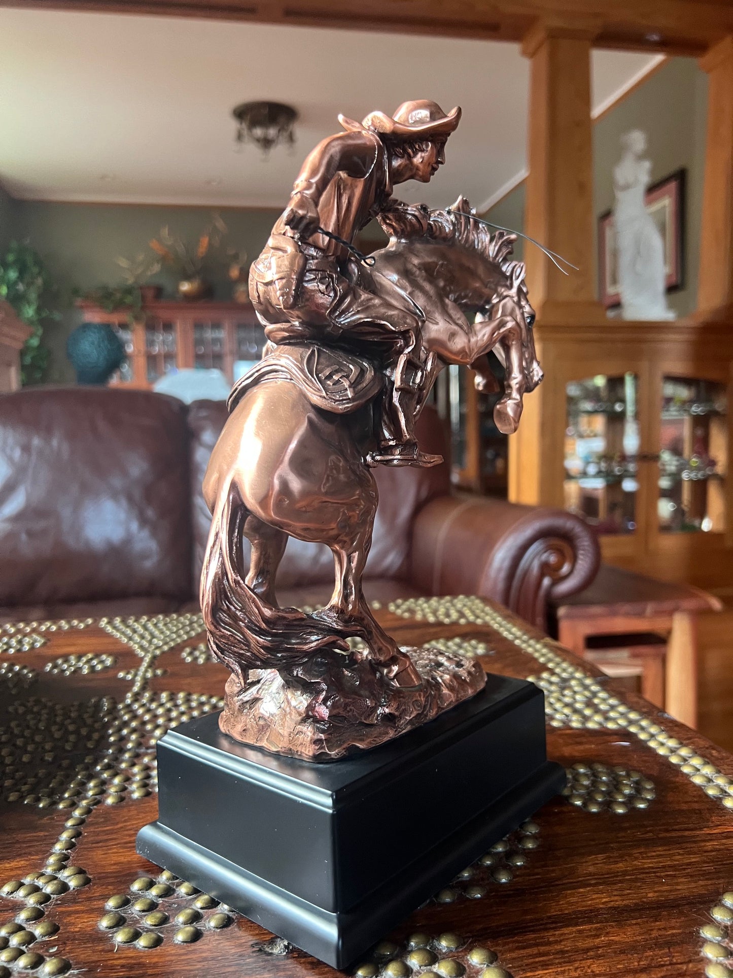 Rodeo rider busting bronco sculpture with black plaque base classical statue