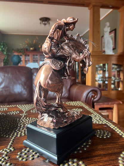 Rodeo rider busting bronco sculpture with black plaque base classical statue