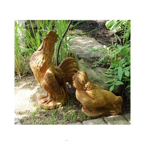 Matching farmhouse chicken statues displayed beside a garden path rooster and hen