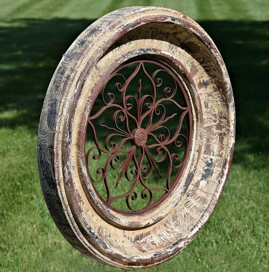 Round distressed wall medallion with carved frame and iron scrollwork center historic European villas