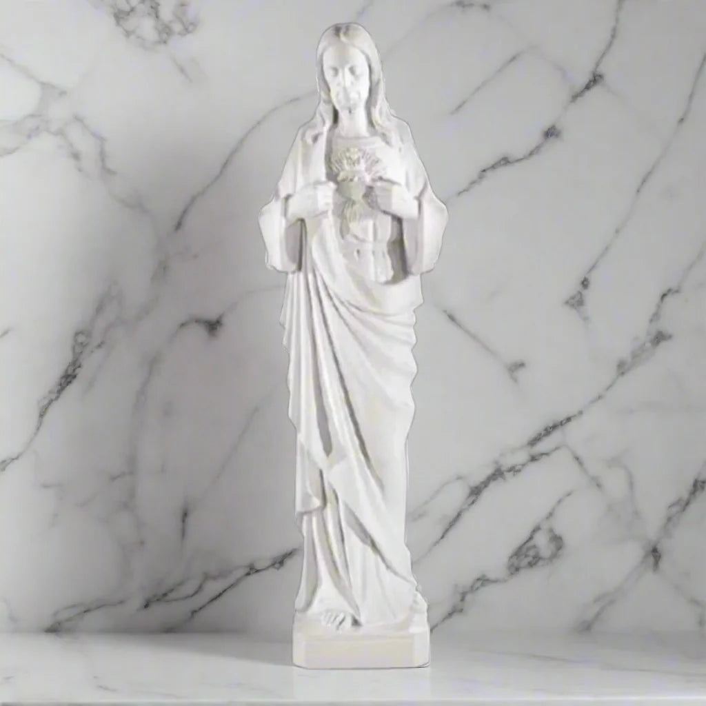 39-inch Sacred Heart of Jesus statue in white Italian marble, displayed in a serene outdoor garden with lush greenery and stone path