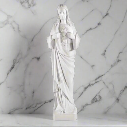 39-inch Sacred Heart of Jesus statue in white Italian marble, displayed in a serene outdoor garden with lush greenery and stone path