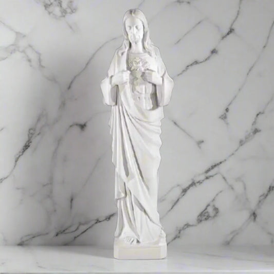 39-inch Sacred Heart of Jesus statue in white Italian marble, displayed in a serene outdoor garden with lush greenery and stone path