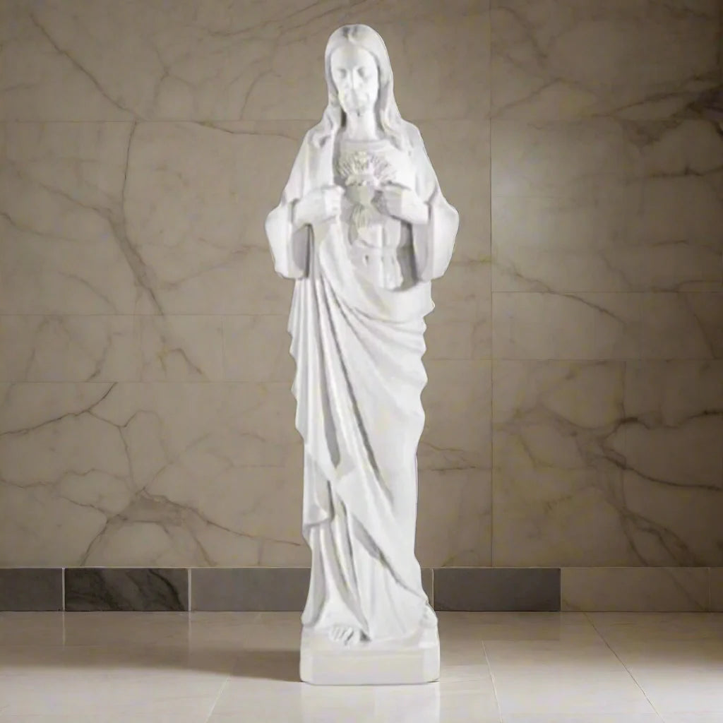 39-inch Sacred Heart of Jesus statue in white Italian marble, displayed in a serene outdoor garden with lush greenery and stone path