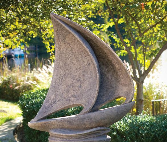 Large sailboat garden statue with sweeping sculpted sails