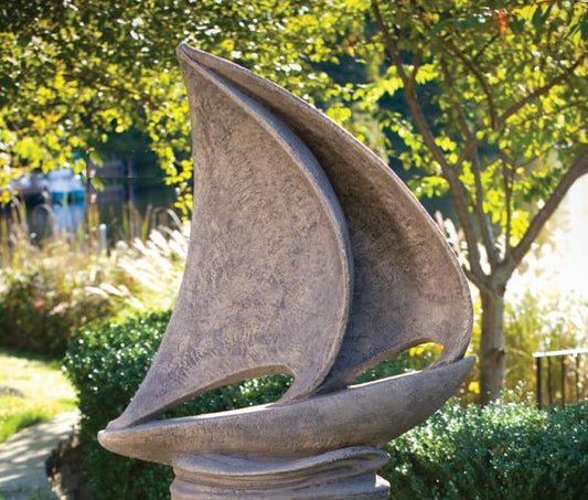 Large sailboat garden statue with sweeping sculpted sails