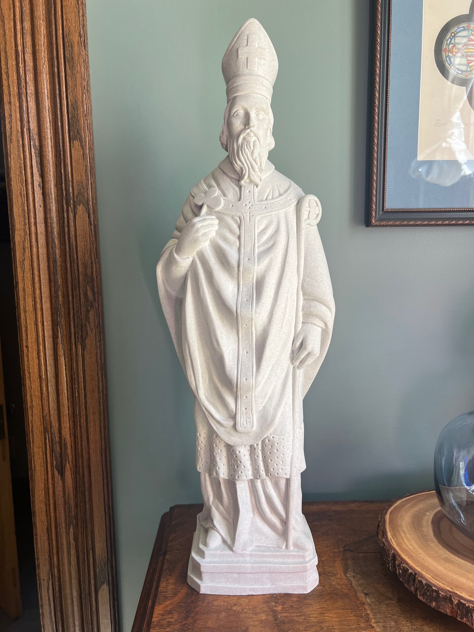 Saint Patrick sculpture faux granite garden statue holding the symbolic shamrock