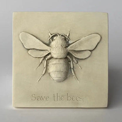 Decorative wall art with a bee design and 'Save the Bees' text on a beige background