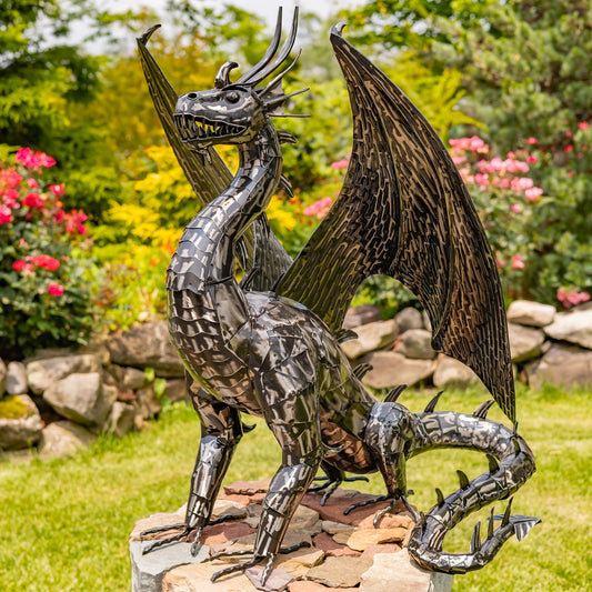 Large metal dragon garden sculpture with glossy distressed metallic finish and spread wings