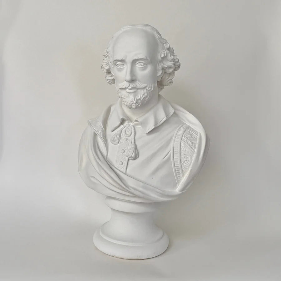 White plaster bust sculpture of William Shakespeare on a matching pedestal base, photographed against a neutral light gray background.
