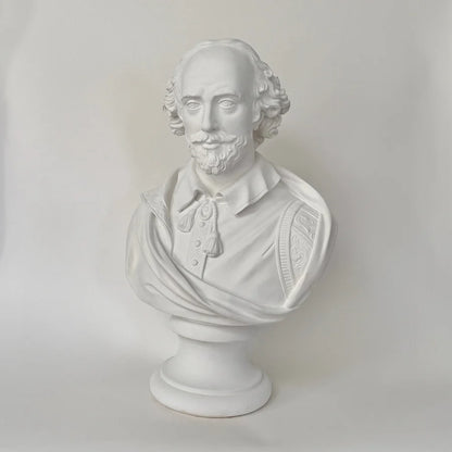 White plaster bust sculpture of William Shakespeare on a matching pedestal base, photographed against a neutral light gray background.