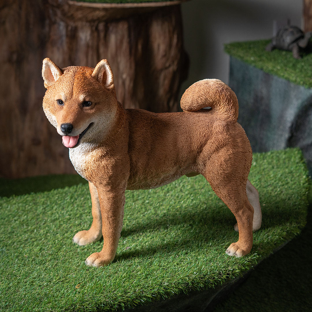 Shiba Inu dog figurine standing on a grass-like surface