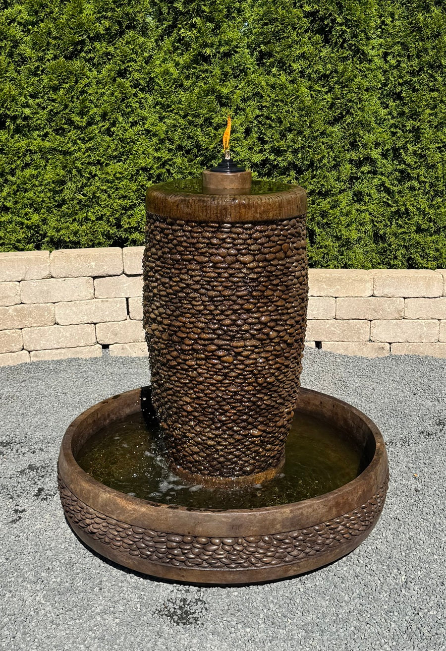 Flame shown Shimmering Stones Slender Garden Fountain with textured pebble column