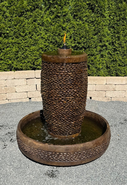Flame shown Shimmering Stones Slender Garden Fountain with textured pebble column