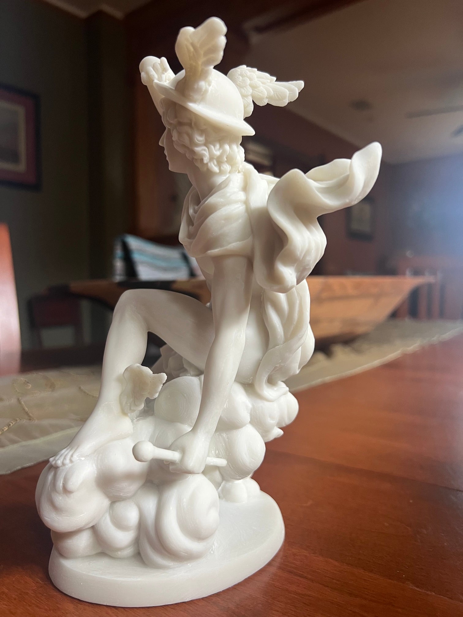 Winged Hermes god of travelers and trade sculpture side view of statue